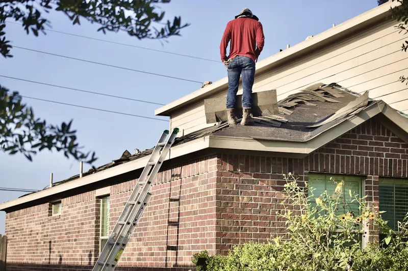 Professional roofer working on a residential roof in Three Oaks